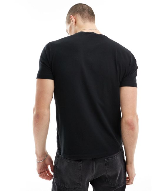 Armani - - t-shirt nera con logo grande dorato sul petto di EA7 in Black da Uomo