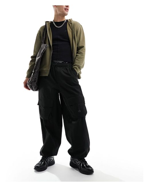 Pantalon ample avec poches cargo élastiques devant ASOS pour homme en coloris Black