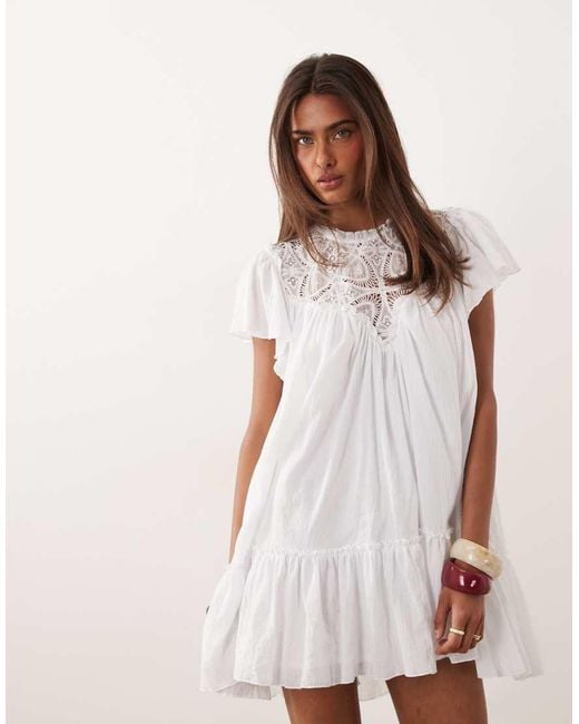 Noughts & Kisses White Crochet Insert Flutter Sleeve Dropped Hem Mini Dress