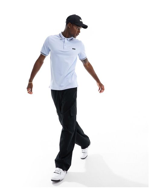 Polo en piqué stretch à liseré multicolore Calvin Klein pour homme en coloris White