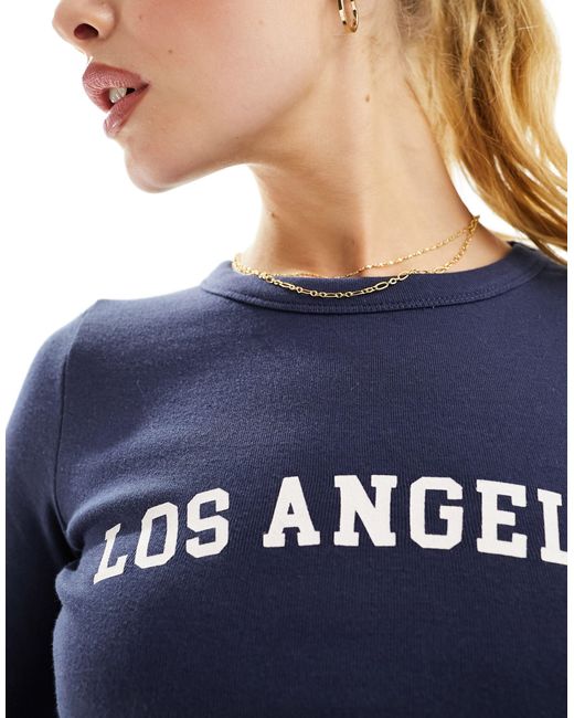 Str - t-shirt mini con scritta "los angeles" di Stradivarius in Blue