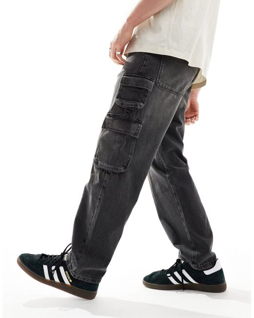 Jeans ampi slavato con dettagli cargo di ASOS in Black da Uomo