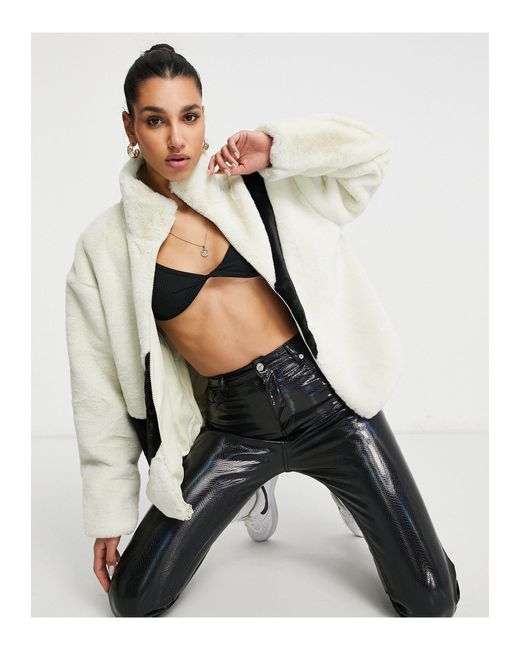 nike faux fur oversized swoosh jacket in cream