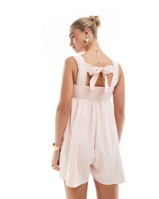 The Frolic Pink Exclusive Cotton Square Neck Lace Trim Bow Embroidered Tie Back Floaty Playsuit
