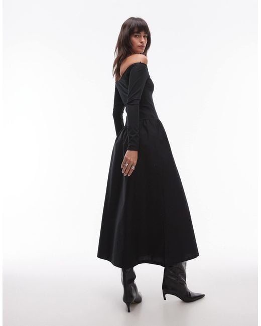 Robe mi-longue avec taille basse et encolure bardot Mango en coloris Black