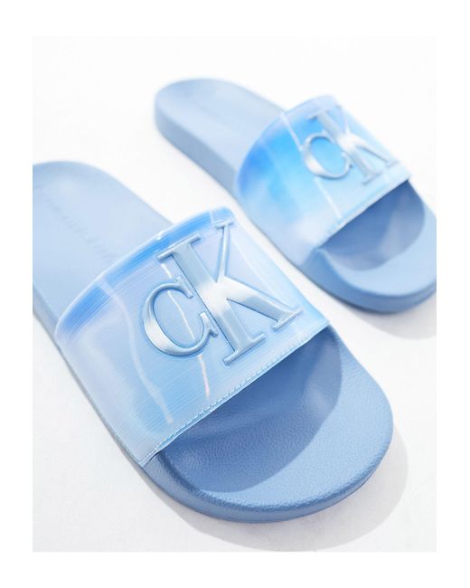 Claquettes en caoutchouc à logo monogramme Calvin Klein en coloris Blue
