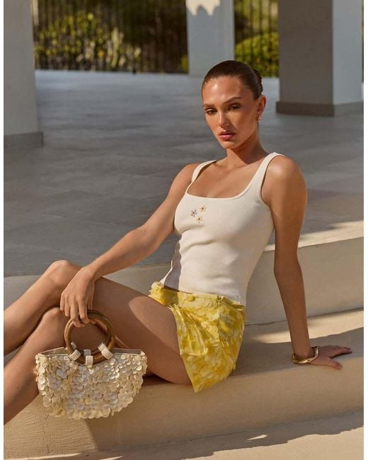 The Frolic White Exclusive Cotton Rich Bead Flower Front Tank Top