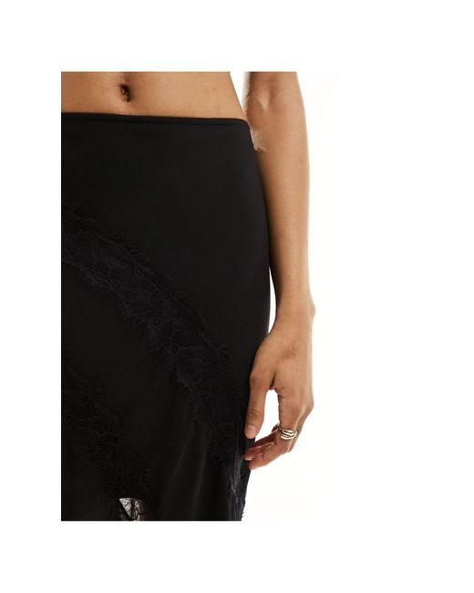 Asos design tall - jupe longue transparente coupée en biais avec empiècements contrastants en dentelle ASOS en coloris Black