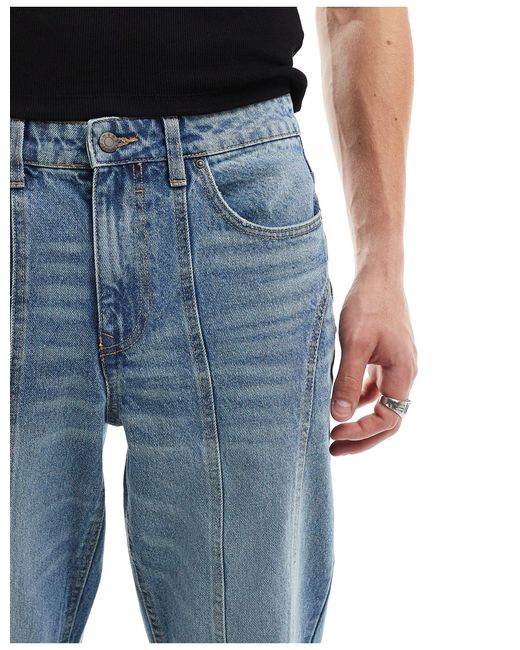 Jeans ampi a zampa lavaggio medio con pannelli di ASOS in Blue da Uomo