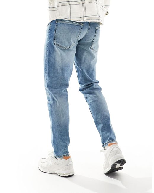 Jeans stretch affusolati lavaggio medio di ASOS in Blue da Uomo