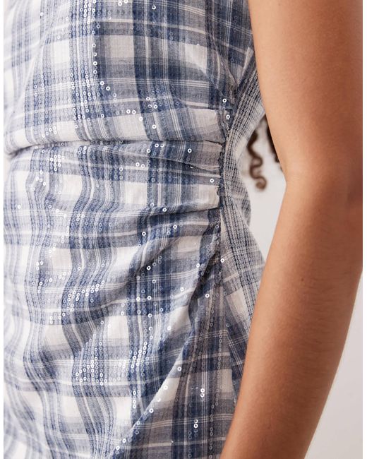 Maya - robe courte et sans manches ornée Ghospell en coloris Blue