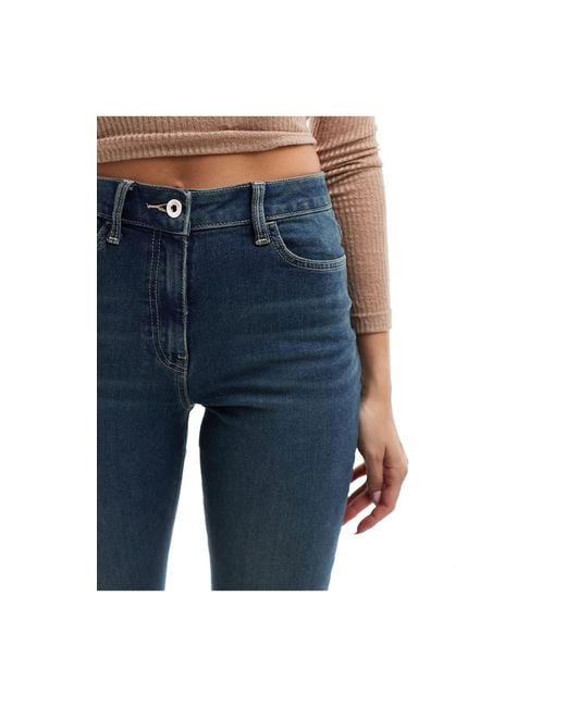 X007 - jeans a zampa elasticizzati lavaggio medio di Collusion in Blue