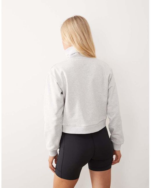 New Balance Natural Athletics Premium Logo Relaxed Fit Cropped Quarter Zip Top