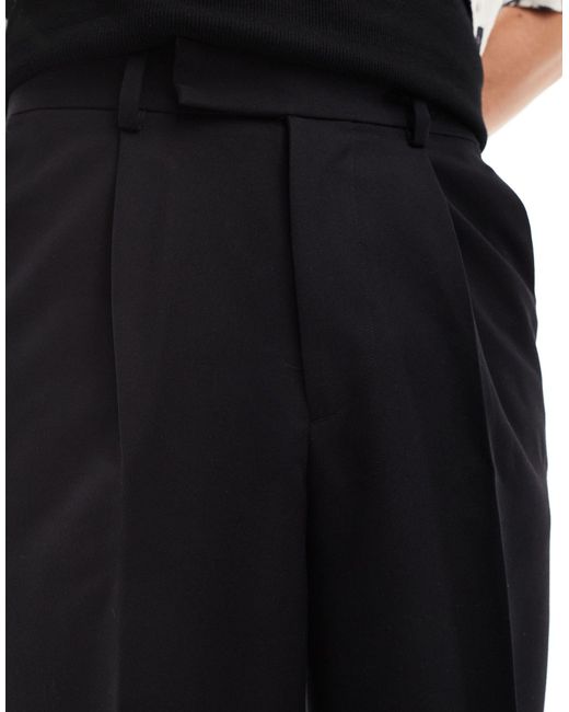Pantaloncini eleganti ampi taglio lungo neri di ASOS in Black da Uomo