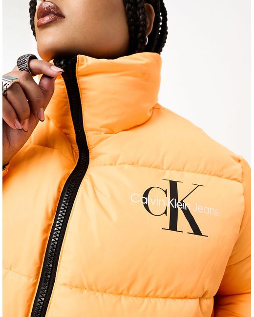 Plus - giacca double-face nera/arancione con monogramma del logo di Calvin Klein in Blue