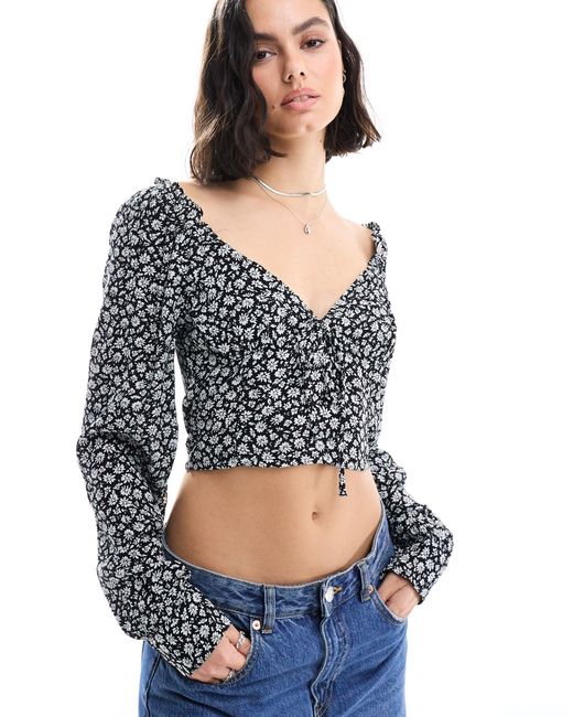 Blusa negra con estampado floral, escote en forma Pimkie de color Blue