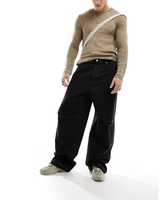 Astro - jeans larghi a fondo ampio neri con strappo sul ginocchio e dettagli invecchiati di Weekday in Black da Uomo
