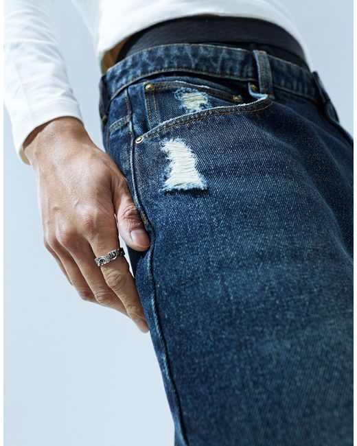 Pantaloncini di jeans taglio molto lungo con abrasioni lavaggio scuro vintage di ASOS in Blue da Uomo