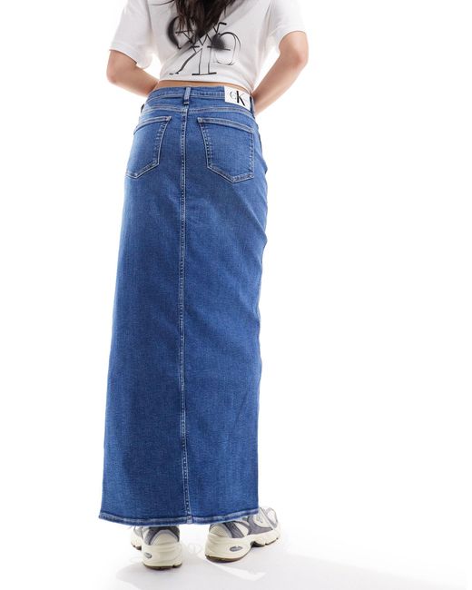 Jupe mi-longue en jean fendue devant - moyen délavé Calvin Klein en coloris Blue