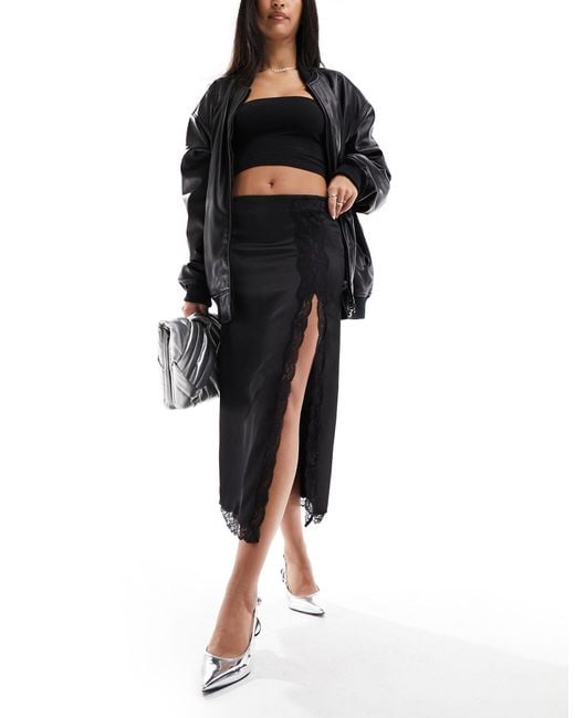 Falda midi negra con abertura delantera Mango de color Black