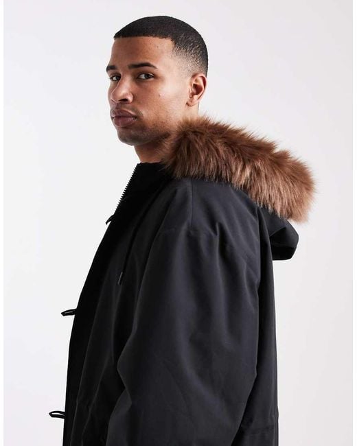 Chaqueta De Plumas Negra Extragrande Con Capucha De Piel Sintética De ASOS de hombre de color Black