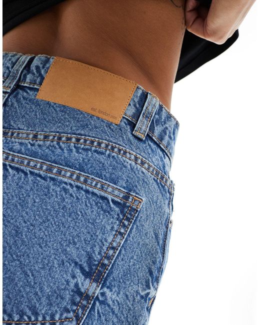 Asos design petite - minigonna di jeans a vita alta medio di ASOS in Blue