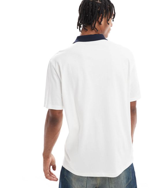 Polo décontracté avec imprimé golf à l'avant ASOS pour homme en coloris White