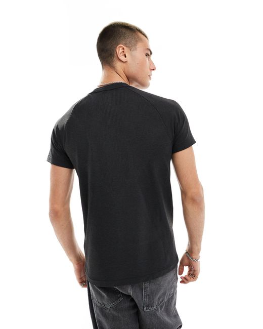 New Balance – t-shirt aus strick in Black für Herren