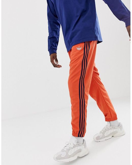Adidas originals - pantalon cigarette à trois bandes - orange hotsell