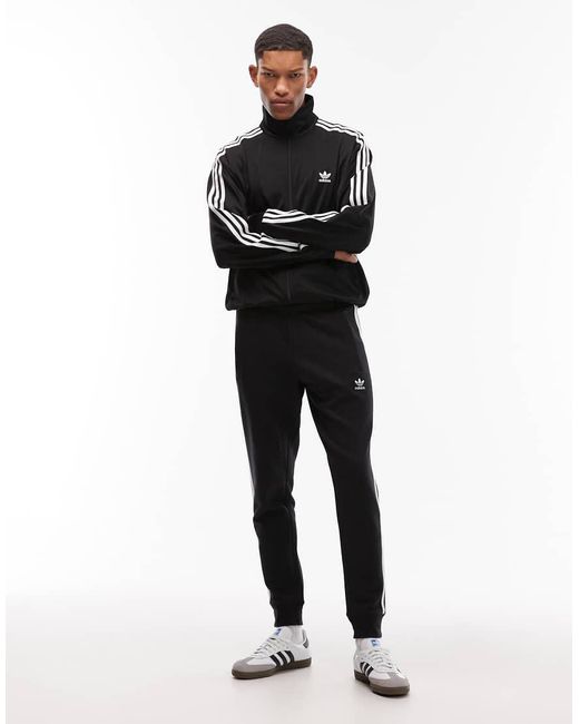 Adidas Originals Blue Three Stripe joggers for men