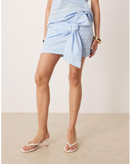 Mini-jupe d'ensemble en coton nouée devant - clair rayé Mango en coloris Blue