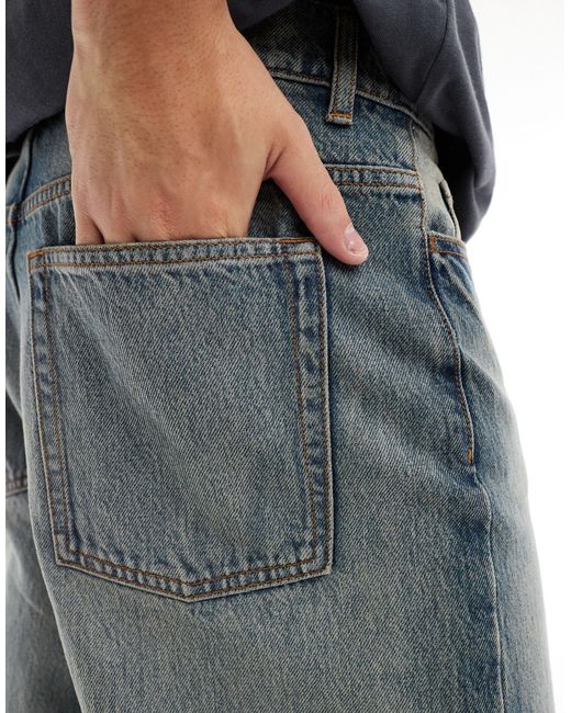 X014 - jeans ampi a vita medio alta lavaggio stone wash antifit di Collusion in Blue da Uomo