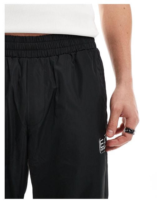 Armani - - joggers con fondo elasticizzato e tasche neri con logo a contrasto di EA7 in Black da Uomo