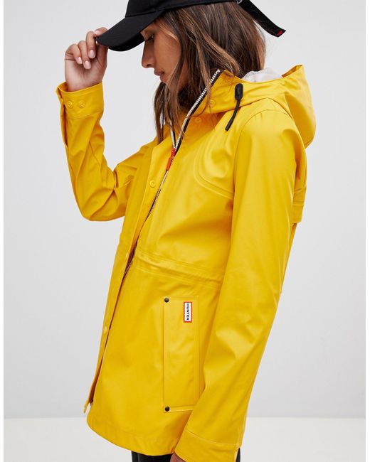 yellow hooded rain mac