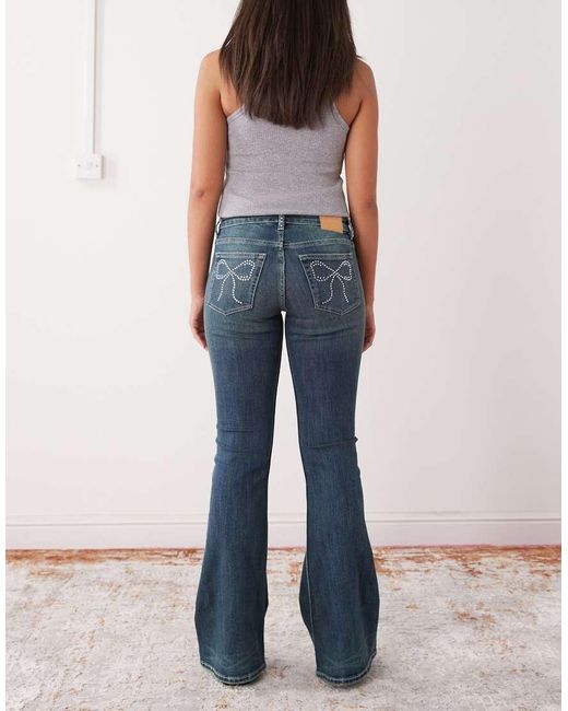 Monki Blue Katsumi Low Waist Flare Jeans With Bow Embellishment