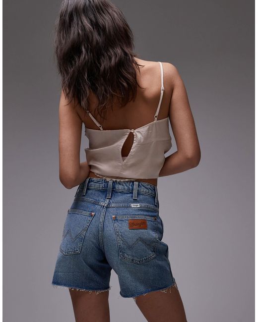 Short 5 pouces style cowboy avec ourlet usé - moyen délavé Wrangler en coloris Blue