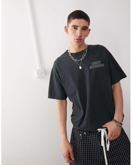 Camiseta Auténtico Pigmentado Con Estampado Gráfico En El Pecho Y La Espalda De Logo Studios De Obey de hombre de color Black