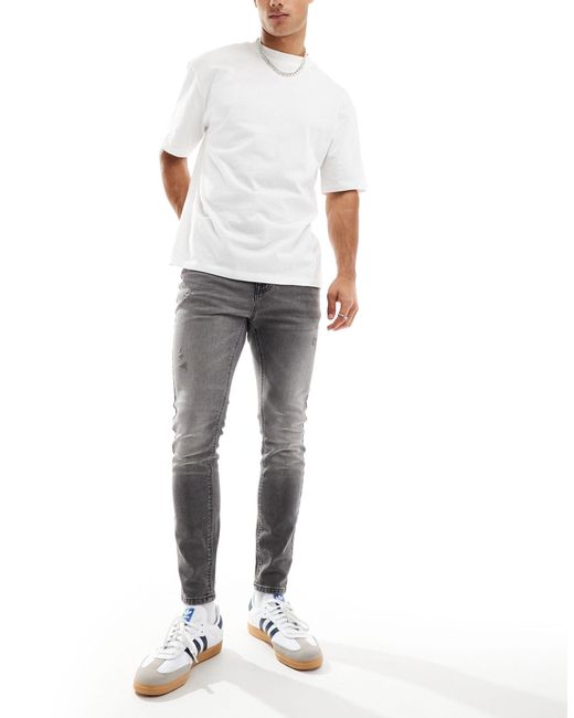 Jeans effetto spray super elasticizzati con strappi e pannelli nero slavato di ASOS in White da Uomo