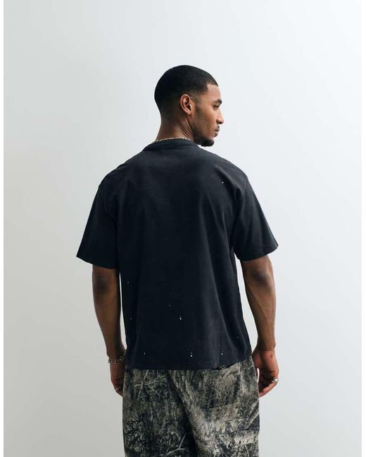 Camiseta Negra Con Estampado Salpicaduras De Pintura Y Logo Efecto Aerografiado Carhartt de hombre de color Blue