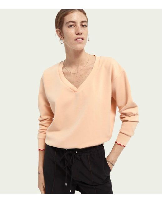 peach sweatshirt