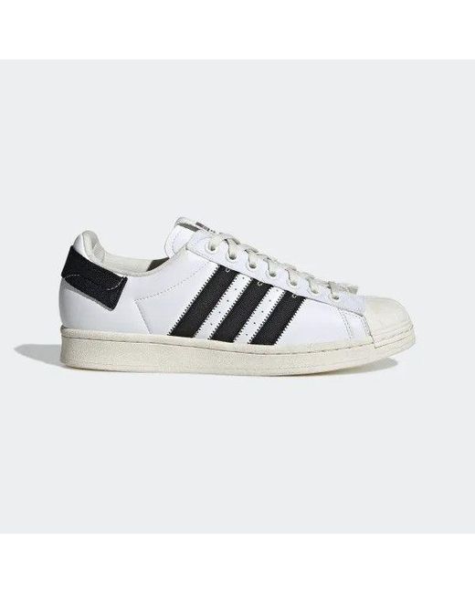 white adidas flat shoes