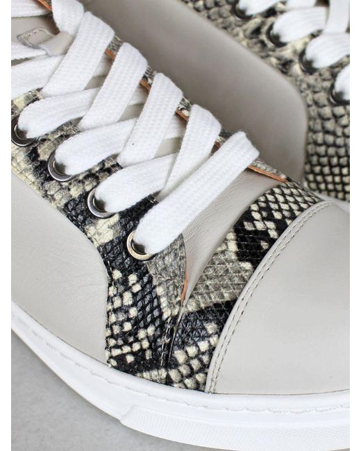 white trainers with snake print