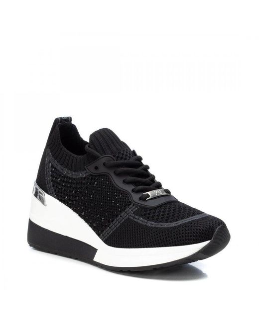 xti black wedge trainers