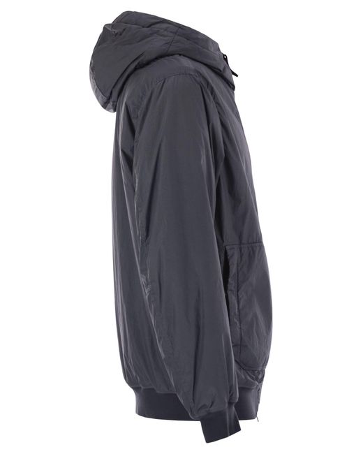 Chaqueta acolchada de con goteo y resistente al viento Stone Island de hombre de color Blue