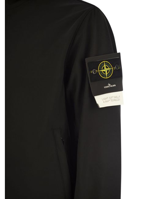 Chaqueta con capucha, agua y viento resistente Stone Island de hombre de color Black