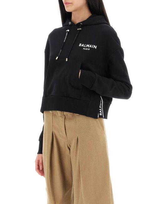 Cropped Sweatshirt mit flockigem Logo -Druck Balmain en coloris Black