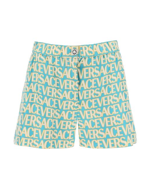 Shorts in seta stampa monogram di Versace in Blue