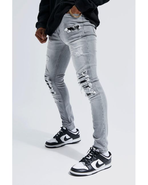 BoohooMAN Super Skinny Stretch Rip & Repair Check Jeans in Black for Men |  Lyst