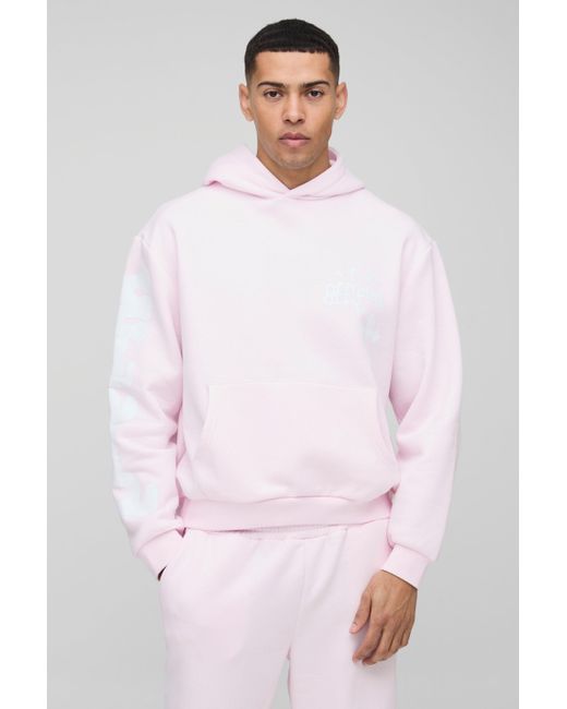 BoohooMAN Kastiger Oversize Trainingsanzug mit Kreuz-Print und Kapuze in Pink für Herren