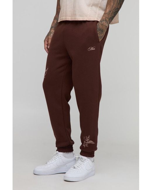 BoohooMAN Brown Tall Regular Fit Cherub Worldwide Print Jogger for men